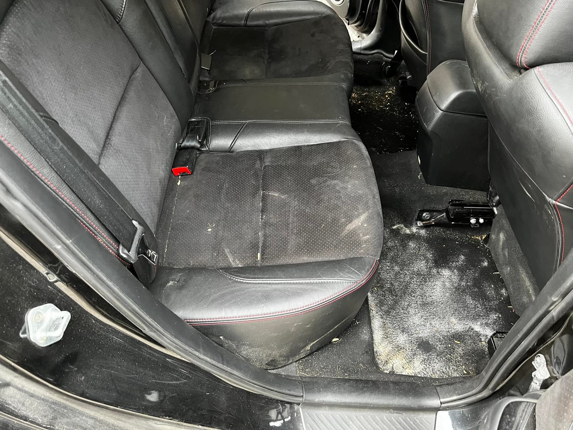 Black leather rear seats & carpet — before