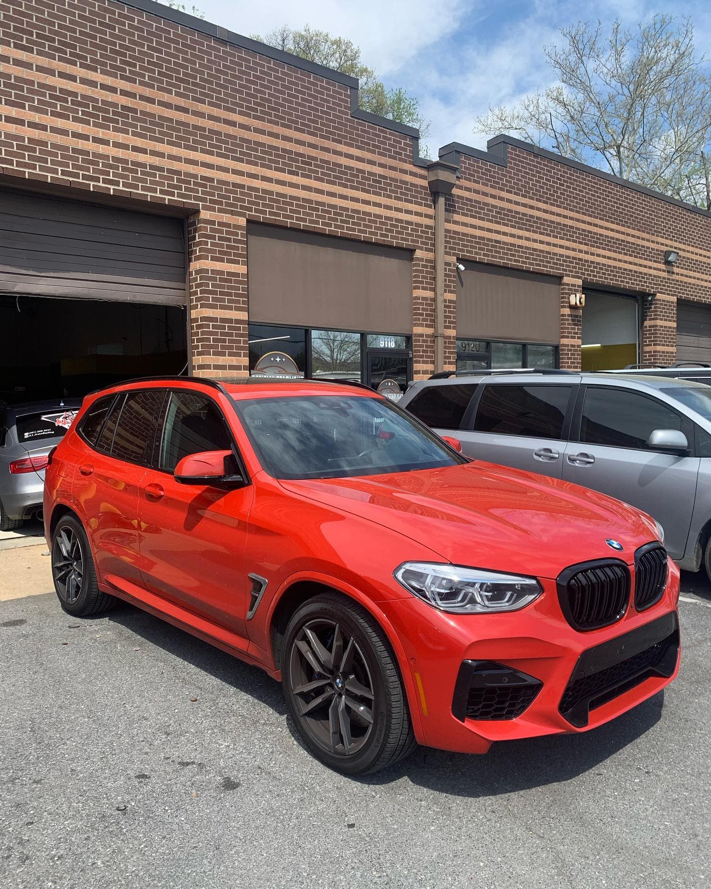 Red BMW X3 ceramic coating mirror finish in Maple Grove