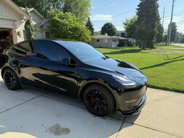 Black Tesla Model Y exterior detailing with wax finish in Newport News