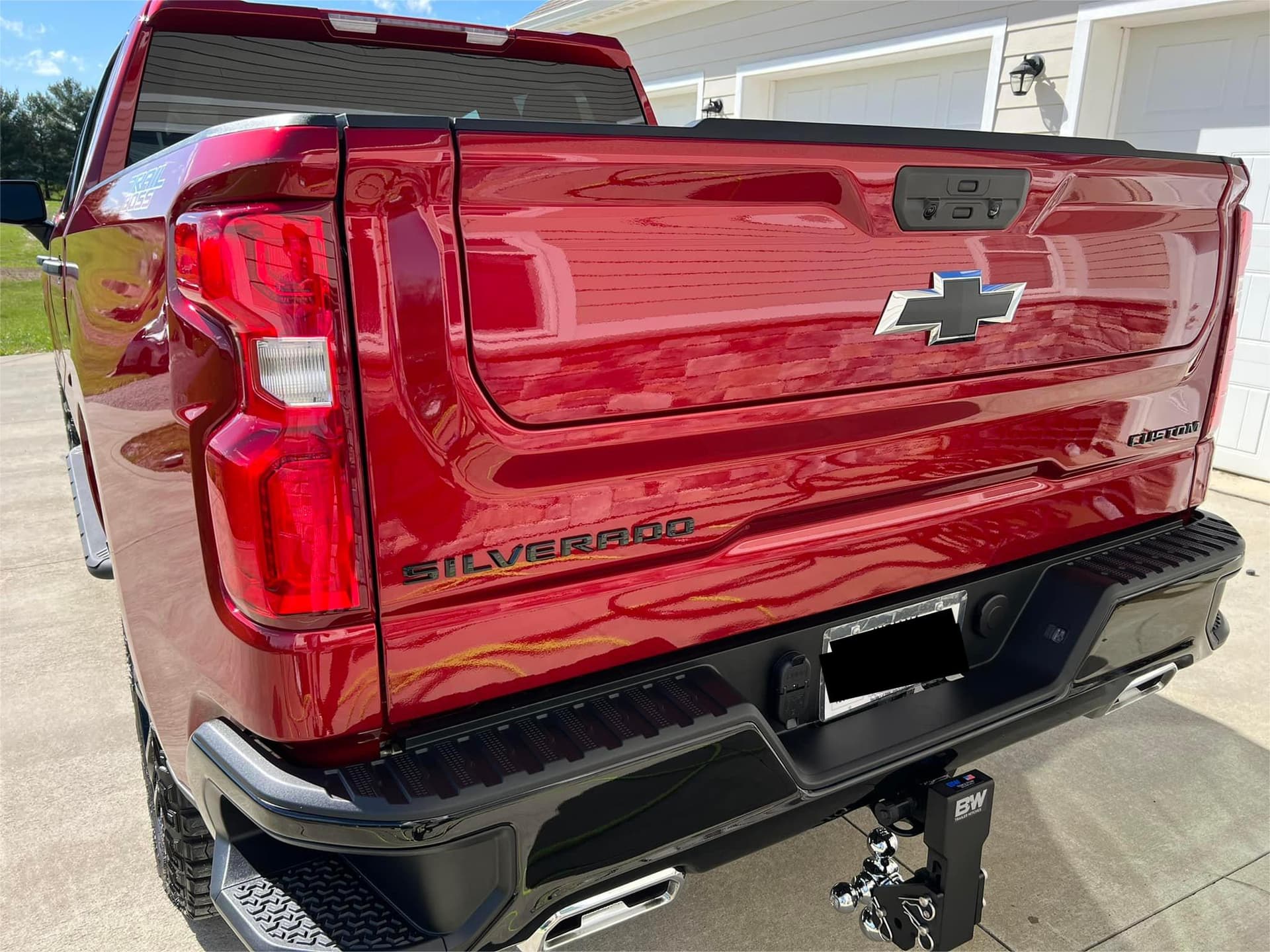 Red Chevrolet Silverado Custom Trail Boss exterior detailing with wax finish in Pelham