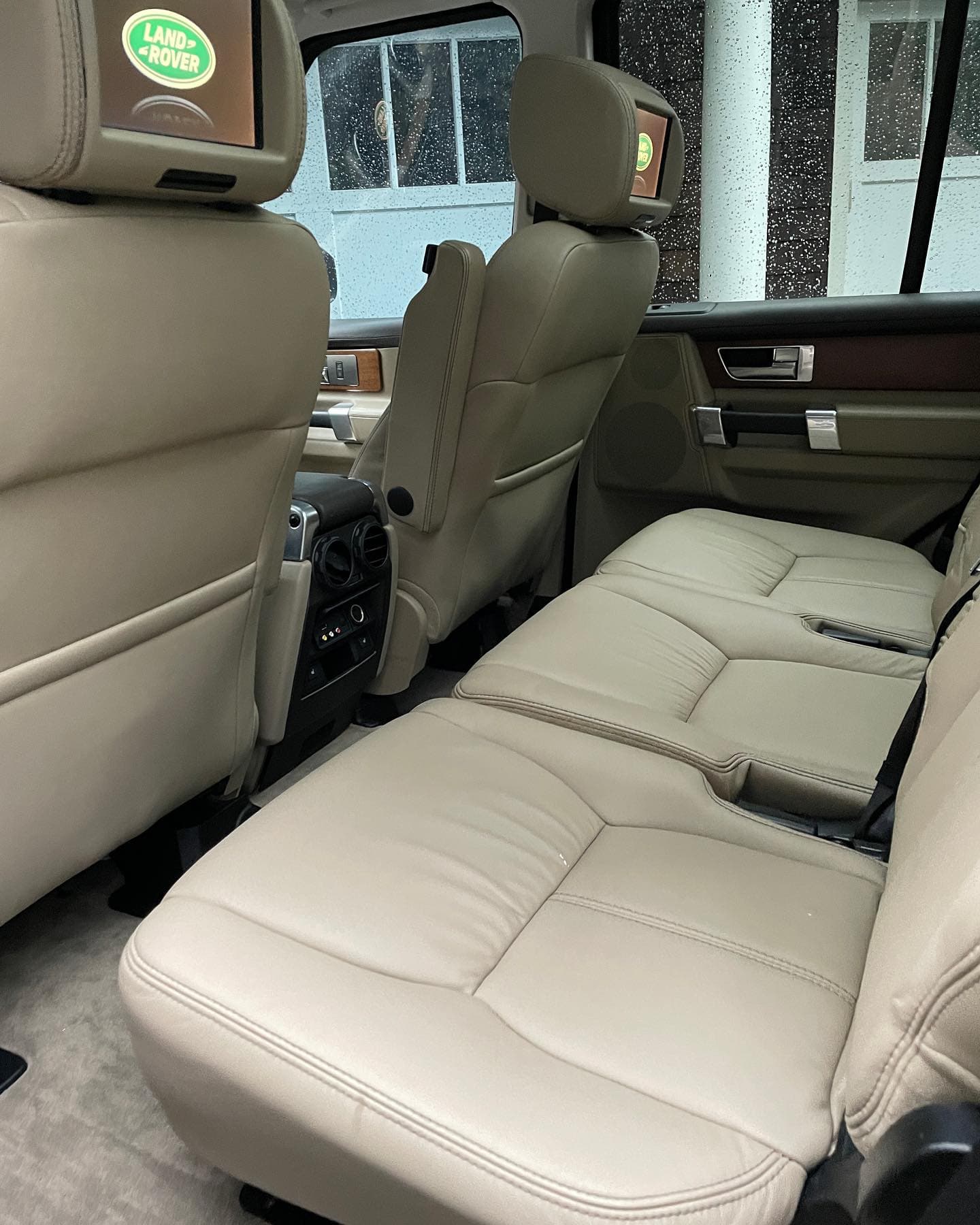 Tan leather Land Rover rear seats with wood trim cleaned in Altamonte Springs
