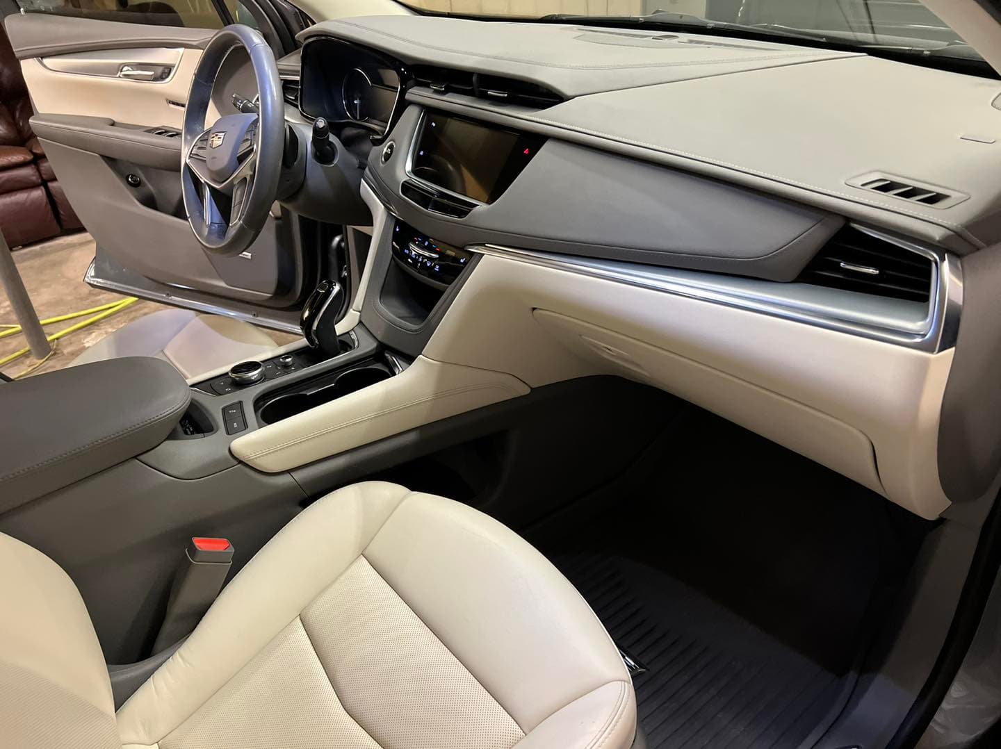 Cream leather Cadillac SUV front cabin interior detailed in Annapolis