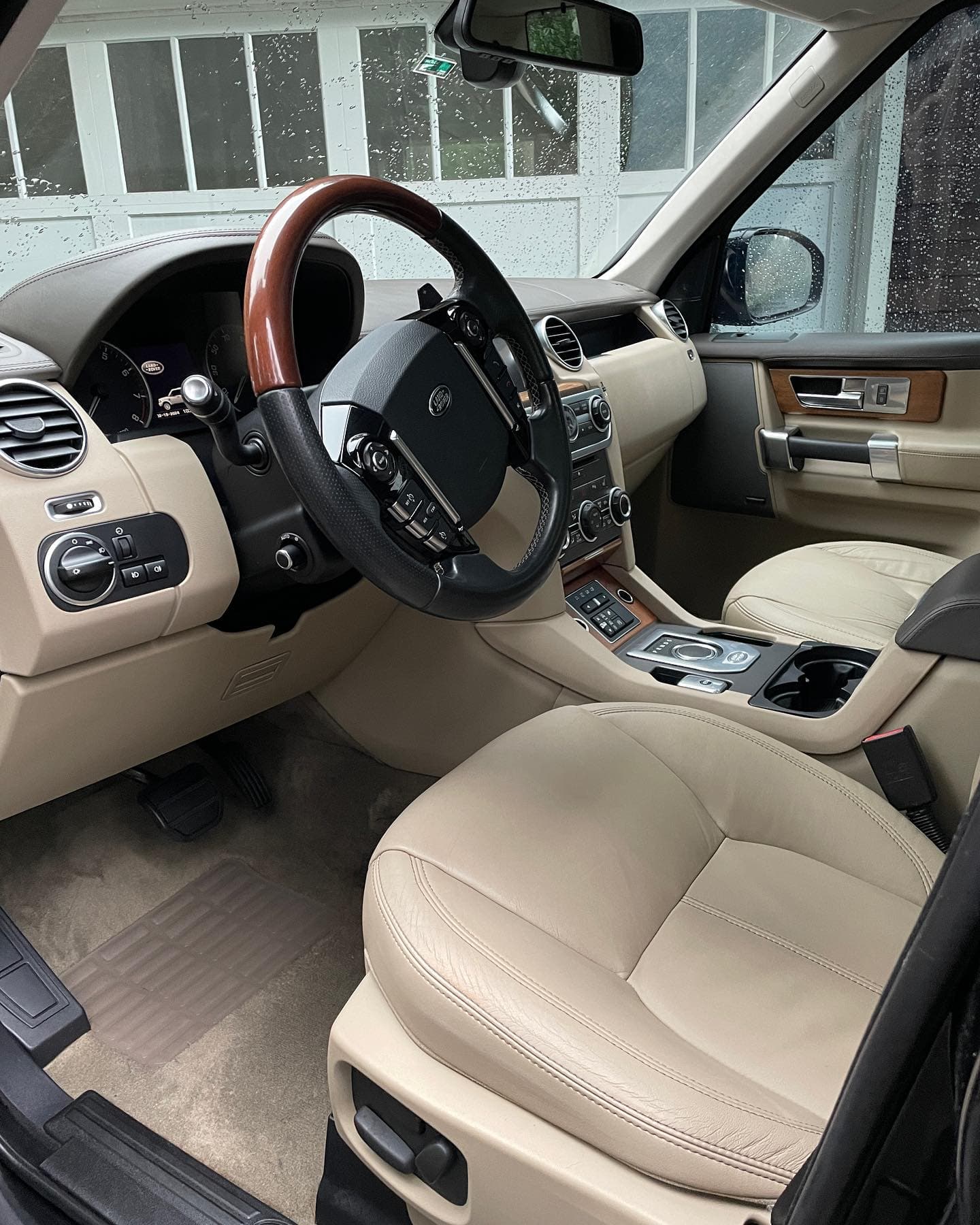 Beige leather Land Rover LR4 interior with wood trim cleaned in Gahanna