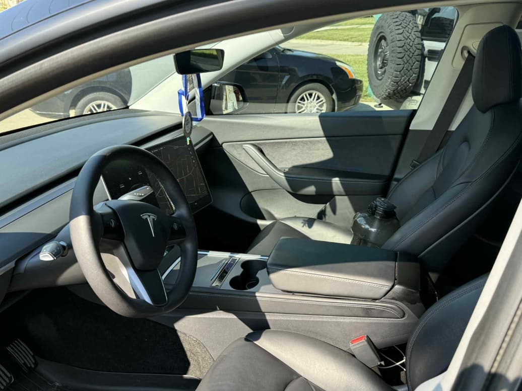Black leather Tesla Model 3 front cabin interior detailed in Plano