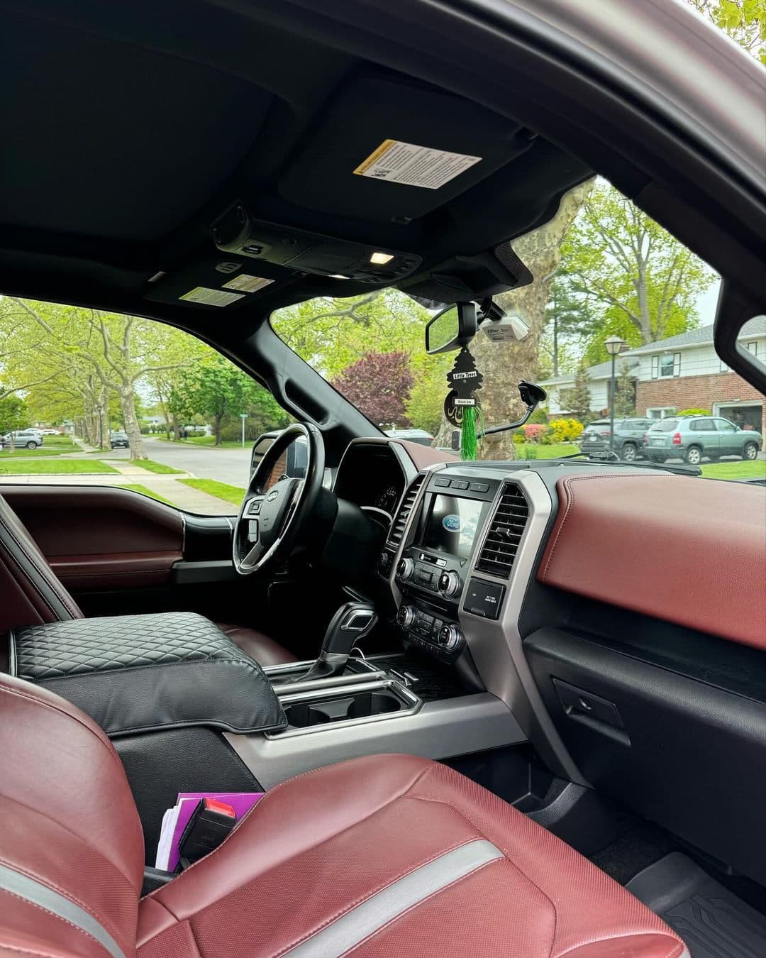 Burgundy leather Ford F-150 dashboard and seats detailed in Santa Clara