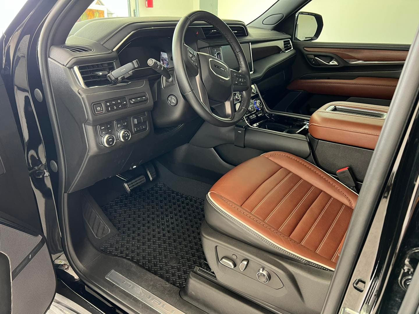 Brown leather GMC Denali driver seat and rubber mat cleaned in Tacoma