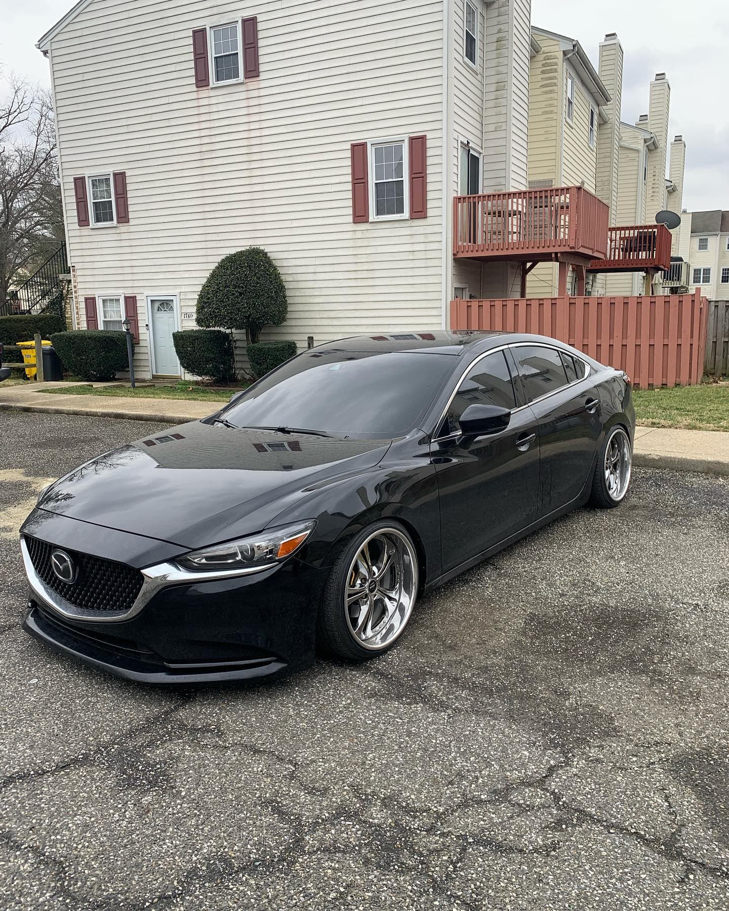 Black sports sedan after paint correction and ceramic coating