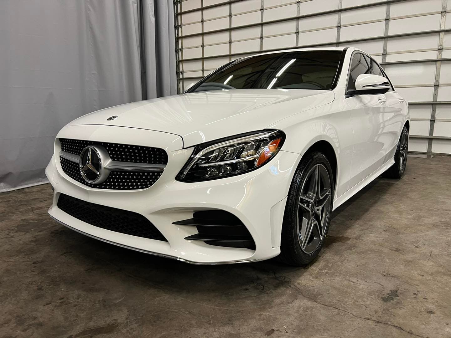 White Mercedes-Benz sedan with wet-look gloss after professional mobile detailing